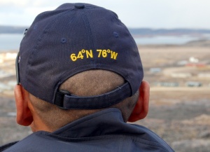 Police officer surveys the hamlet of
Cape Dorset on Baffin Island, his cap
revealing its geographic location