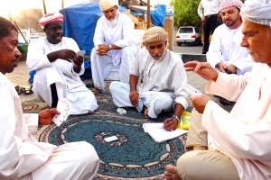 Merchants in an Al-Buraimi, Oman
market take a card-game break