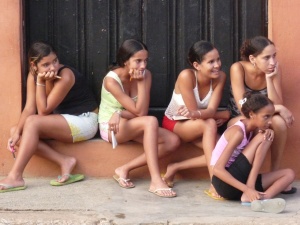 Cuban girls in Baracoa judge a junior dance competition held in the street