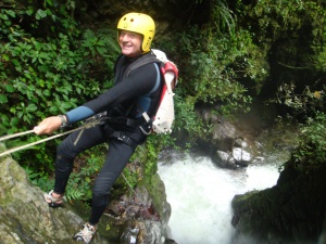 Canyoning near Merida, Venezuela; starting the descent of the 27-meter waterfall
